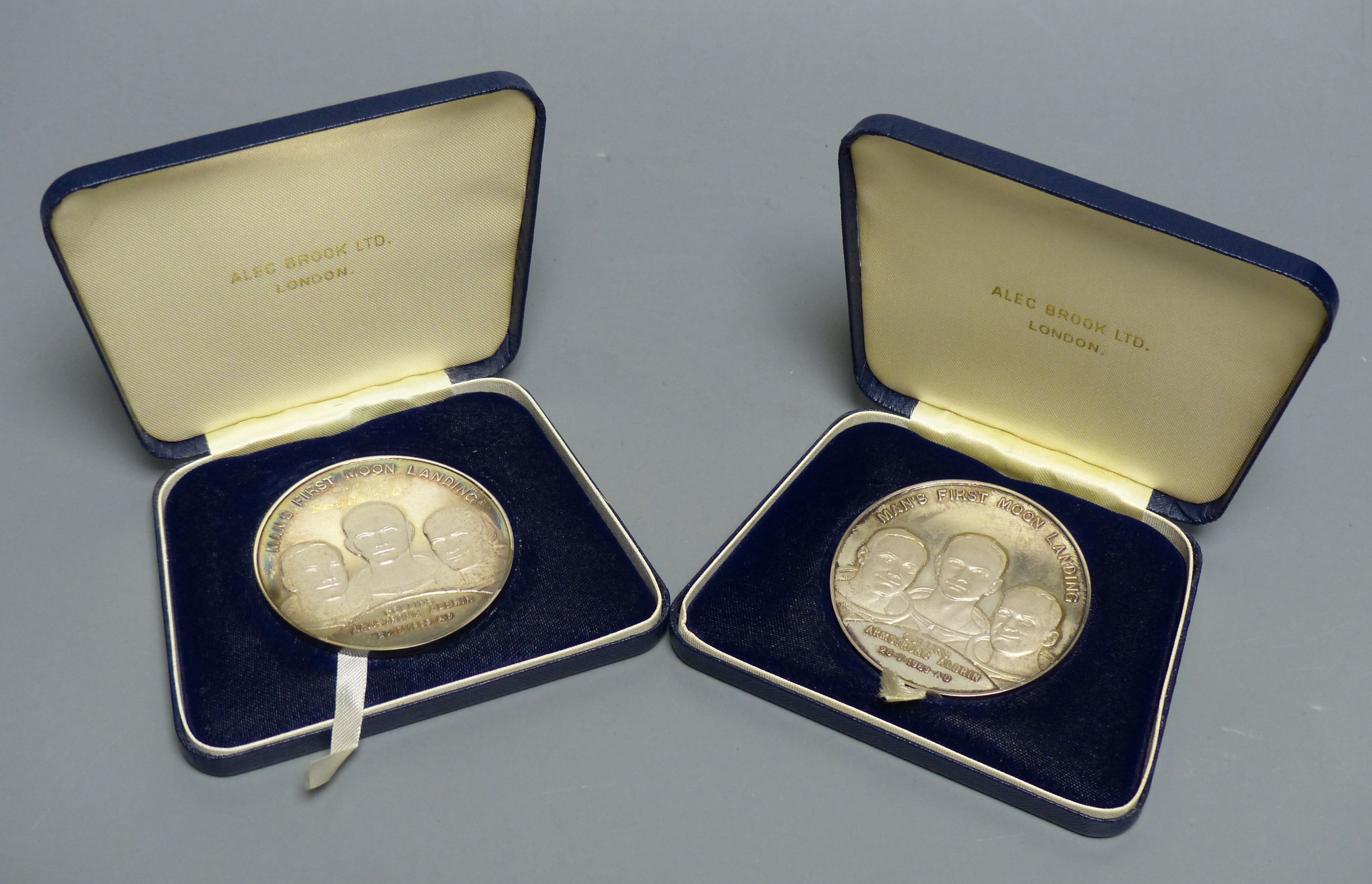 Two sterling silver limited edition 'Man's First Moon Landing' commemorative medals, cased